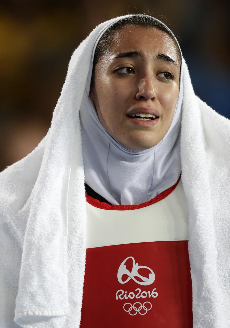 FILE- In this Aug. 18, 2016 file photo, Kimia Alizadeh Zenoorin, of Iran, cries as she leaves the arena after losing a quarterfinal match to Eva Calvo Gomez, of Spain, in women's 57-kg taekwondo at the 2016 Summer Olympics in Rio de Janeiro, Brazil. Zenoorin, Iran's only female Olympic medalist, said she defected from the Islamic Republic in a blistering online letter that describes herself as “one of the millions of oppressed women in Iran.” (AP Photo/Robert F. Bukaty, File)