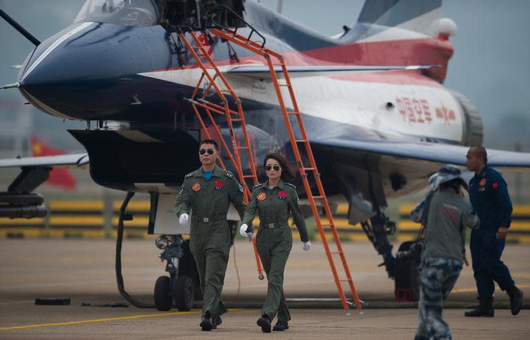 The female and a male pilot of a J-10 fighter jet