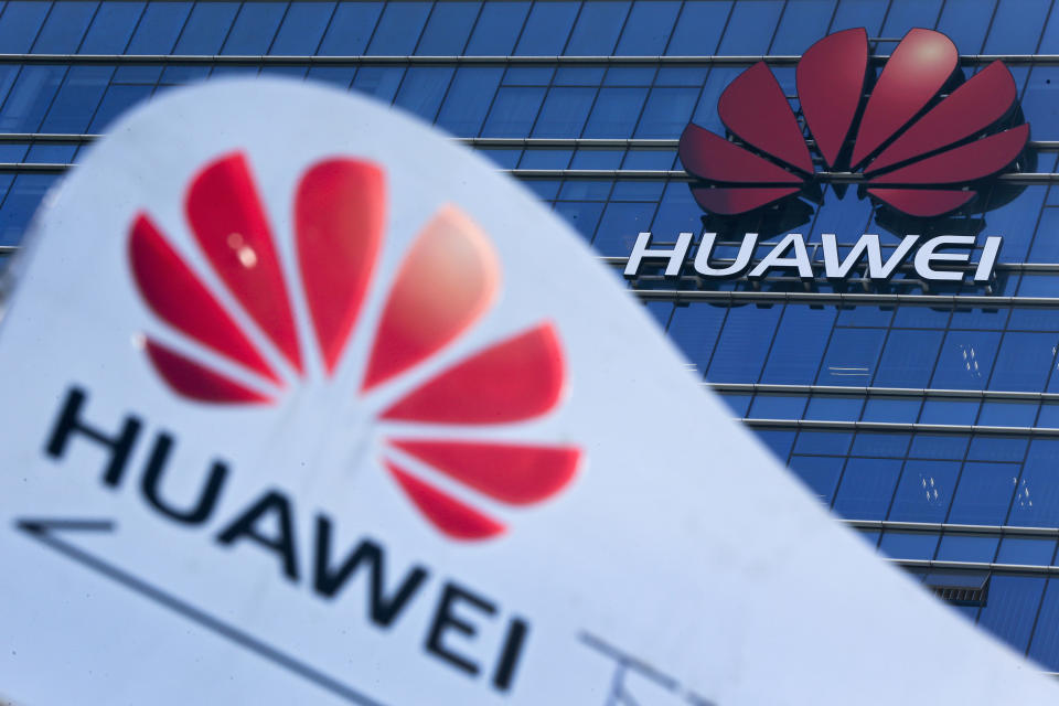 FILE - This Dec. 18, 2018, file photo, shows company signage on display near the Huawei office building at its research and development center in Dongguan, in south China's Guangdong province. China says the U.S. is using a double standard in claiming Chinese law requires telecoms giant Huawei to violate other countries' information security. (AP Photo/Andy Wong, File)