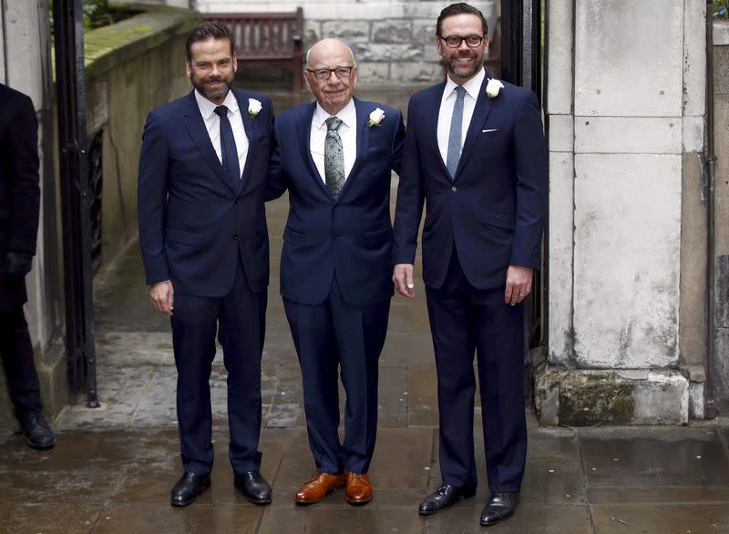 FILE PHOTO: Rupert Murdoch poses for a photograph with his sons Lachlan and James as they arrive at St Bride's church for a service to celebrate the wedding between Murdoch and Jerry Hall in London