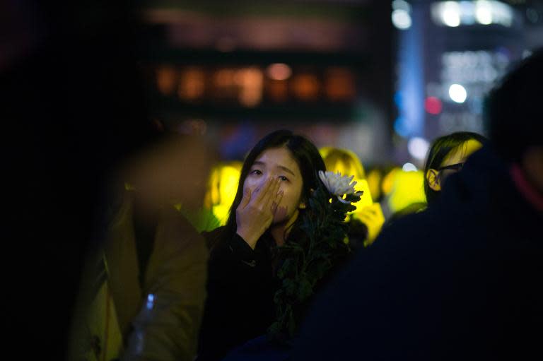 A mourner weeps during a rally marking the first anniversary of the Sewol ferry disaster, in Seoul on April 16, 2015