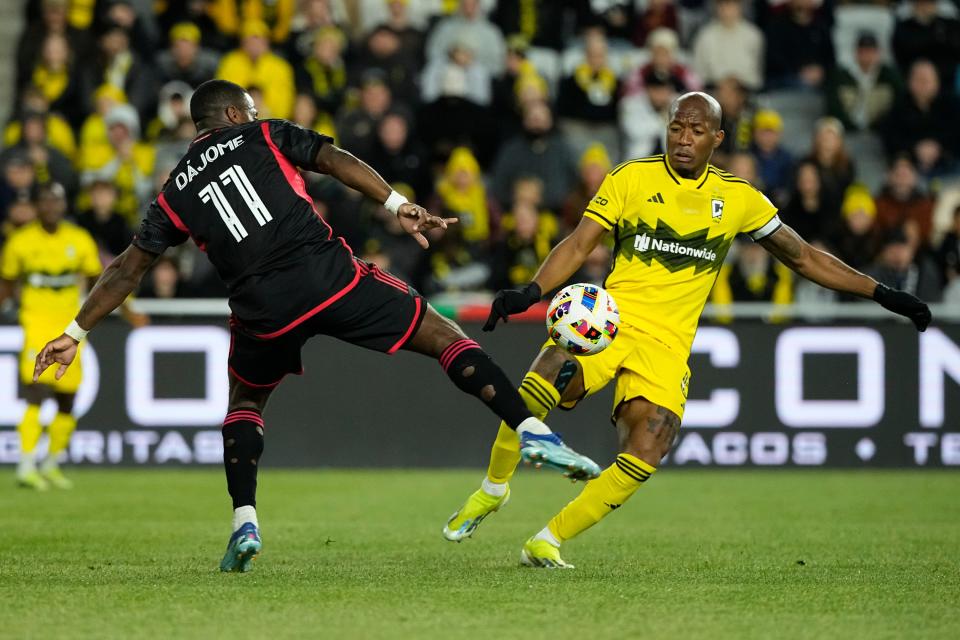 April 6, 2024;  Columbus, Ohio, USA;  Columbus Crew midfielder Darlington Nagbe (6) and DC United forward Cristian Dajome (11) battle for a ball during the second half of the MLS soccer match at Lower.com Field.