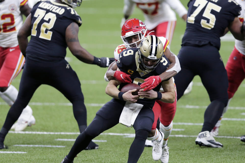 Kansas City Chiefs cornerback L'Jarius Sneed (38) brings down New Orleans Saints quarterback Drew Brees (9) in the first half of an NFL football game in New Orleans, Sunday, Dec. 20, 2020. (AP Photo/Brett Duke)