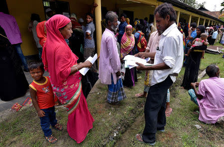 REFILE - UPDATING BYLINE Villagers wait outside the National Register of Citizens (NRC) centre to get their documents verified by government officials, at Mayong Village in Morigaon district, in the northeastern state of Assam, India July 8, 2018. Picture taken July 8, 2018. REUTERS/Stringer