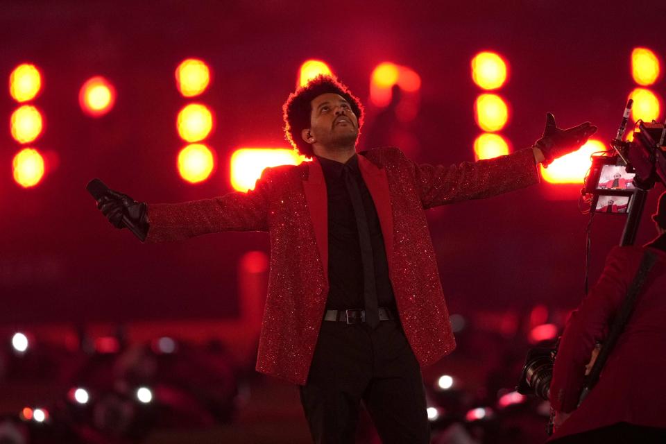 FILE - The Weeknd performs during the halftime show of the NFL Super Bowl 55 football game between the Kansas City Chiefs and Tampa Bay Buccaneers in Tampa, Fla. on Feb. 7, 2021. The Weeknd had the No. 1 song of 2020 but “Blinding Lights” was not nominated for a Grammy Award. (AP Photo/Chris O'Meara, File)
