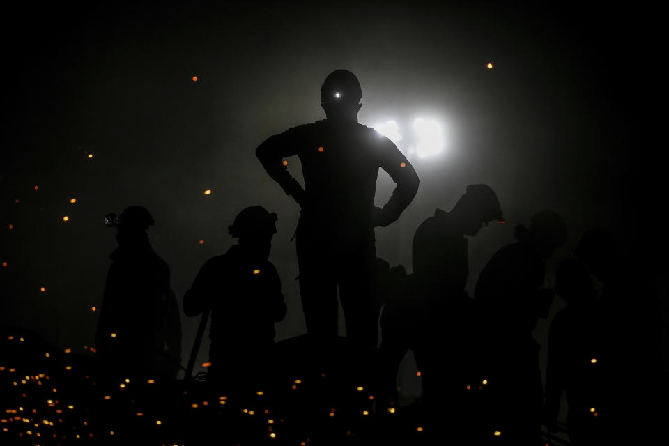 Members of rescue services search for survivors in the debris of a collapsed building in Izmir, Turkey, Monday, Nov. 2, 2020. In scenes that captured Turkey's emotional roller-coaster after a deadly earthquake, rescue workers dug two girls out alive Monday from the rubble of collapsed apartment buildings three days after the region was jolted by quake that killed scores of people. Close to a thousand people were injured. (AP Photo/Emrah Gurel)