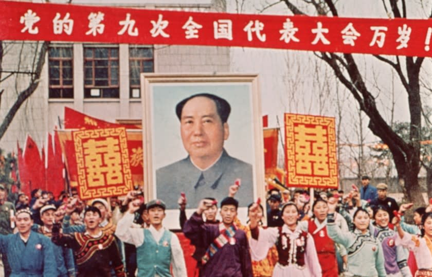 circa 1968: People marching down the street carrying a large poster of Chairman Mao Zedong (1893 - 1976) during the Cultural Revolution, China. (Photo by Hulton Archive/Getty Images)