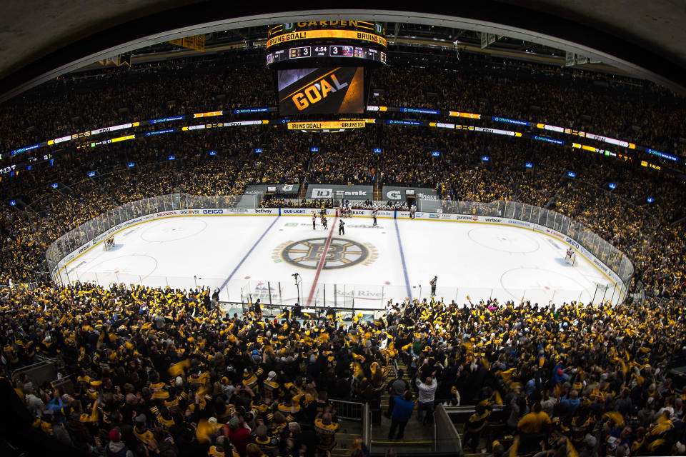 In this photo taken with a wide angle lens, Boston Bruins fans celebrate after the team tied Game 2 in the third period during an NHL hockey second-round playoff series against the New York Islanders, Monday, May 31, 2021, in Boston. (AP Photo/Winslow Townson)
