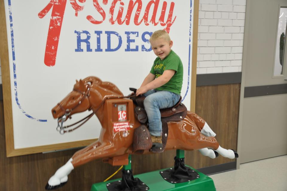 Minerva resident Angela Henning's 4-year-old son, Tobias, rides Meijer's penny pony, Sandy, inside the new Alliance supercenter, which opened Tuesday, May 14, 2024. "I love Meijer," she said.