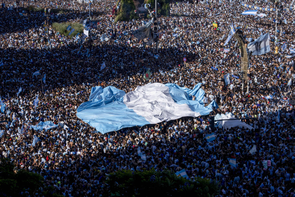 Argentine soccer fans celebrate their team's World Cup victory over France, in Buenos Aires, Argentina, Sunday, Dec. 18, 2022. (AP Photo/Victor R. Caivano)