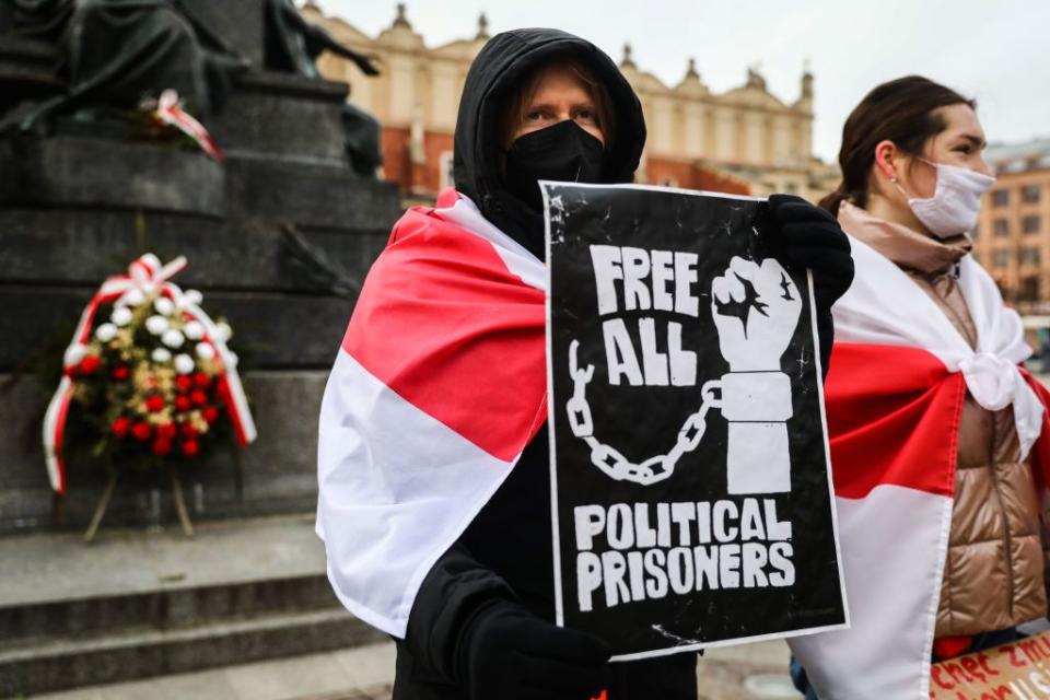 A protestor holds a banner “Free All Political Prisoners” during a demonstrate of solidarity with Belarusian political prisoners and against Alexander Lukashenko's dictatorship in Krakow, Poland on Jan. 16, 2022. (Beata Zawrzel/NurPhoto via Getty Images)