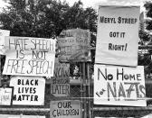 <p>Protest signs hang on a fence inside Boston Common after a counterprotest against a “free speech” rally staged by conservative activists Aug. 19 in Boston. (Photo: Holly Bailey/Yahoo News) </p>