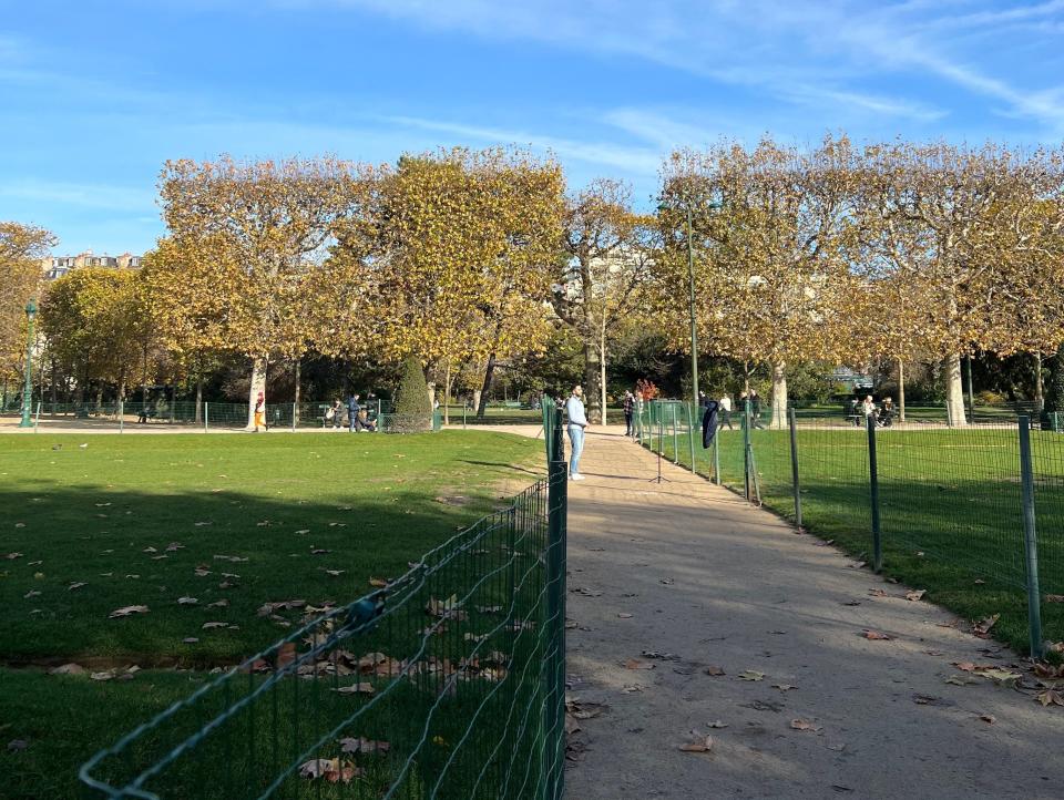 The beautiful green spaces behind the Eiffel Tower are fenced off.