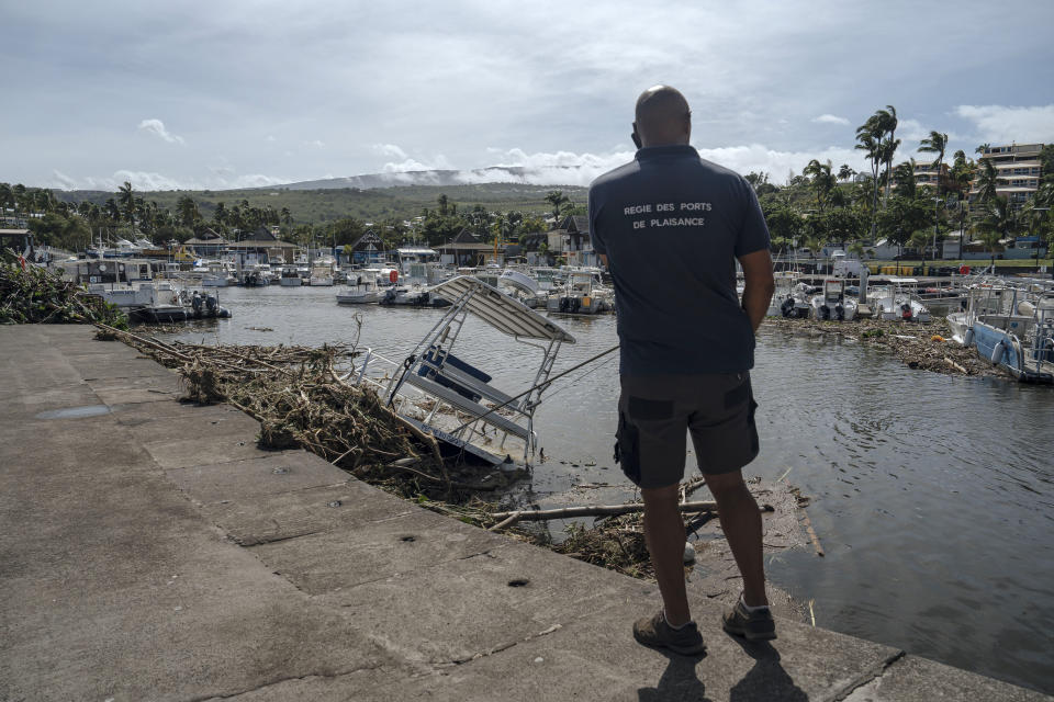 A man inspects damages in the marina of Saint-Gilles les Bains on the French Indian Ocean island of Reunion, Tuesday, Jan. 16, 2024. Tropical cyclone Belal had battered the French island of Reunion, where the intense rains and powerful winds left about a quarter of households without electricity after hitting Monday morning, according to the prefecture of Reunion. (AP Photo/Lewis Joly)