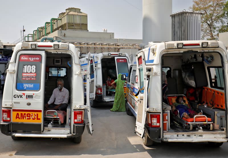 Patient wait inside ambulances in a queue to enter a COVID-19 hospital, in Ahmedabad