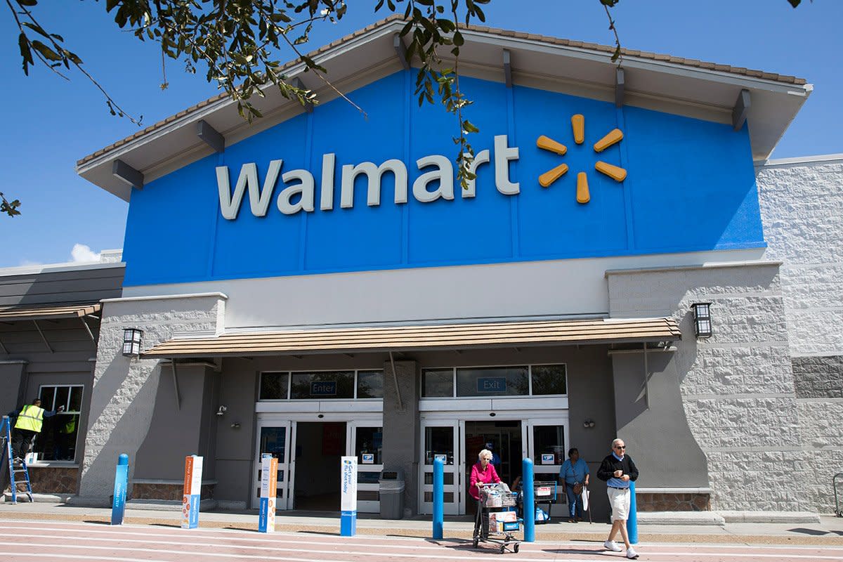 Shoppers enter and leave Walmart.