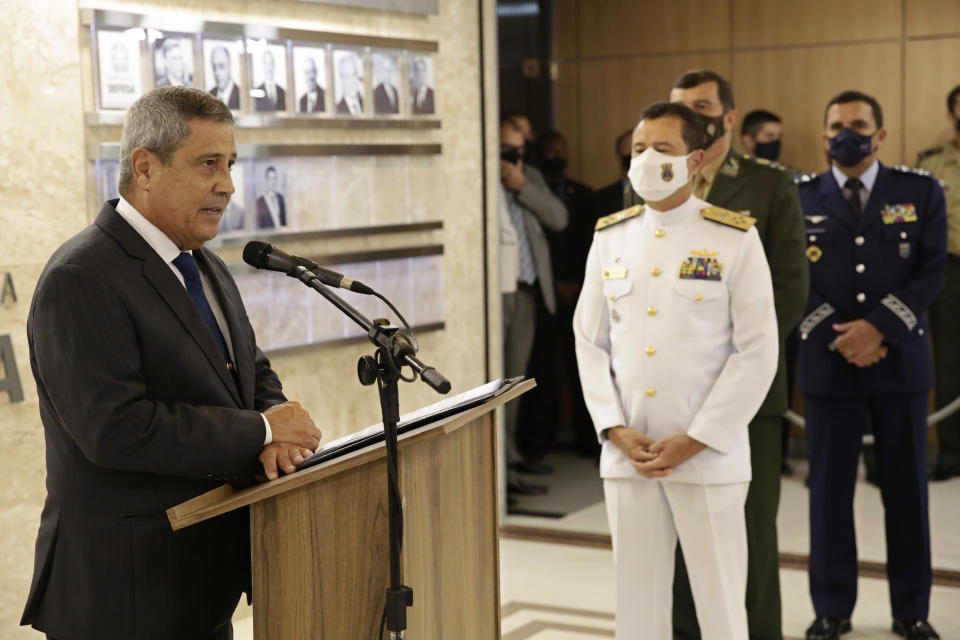 Brazil’s new defense minister Walter Braga Netto, left, speaks during the presentation of the three new military commanders, Navy commander Admiral Almir Garnier, second left, Army commander General Paulo Sergio, second right, and Air Force commander Brigadier Carlos de Almeida Baptista Jr., right, at the Ministry of Defense headquarters in Brasilia, Brazil, Wednesday, March 31, 2021. The new leaders of all three branches of Brazil's armed forces were named after the previous ones jointly resigned following President Jair Bolsonaro's replacement of the defense minister, causing widespread apprehension of a military shakeup to serve the president's political interests. (AP Photo/Eraldo Peres)