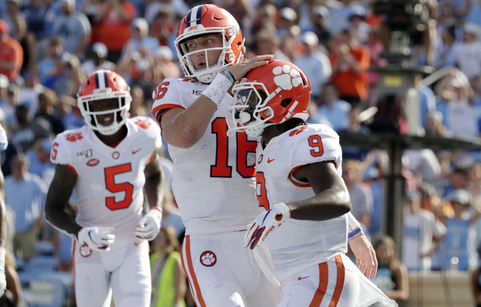 Clemson's Travis Etienne (9) celebrates his touchdown with Trevor Lawrence (16) and Tee Higgins (5) during the second quarter of an NCAA college football game against North Carolina in Chapel Hill, N.C., Saturday, Sept. 28, 2019. (AP Photo/Chris Seward)