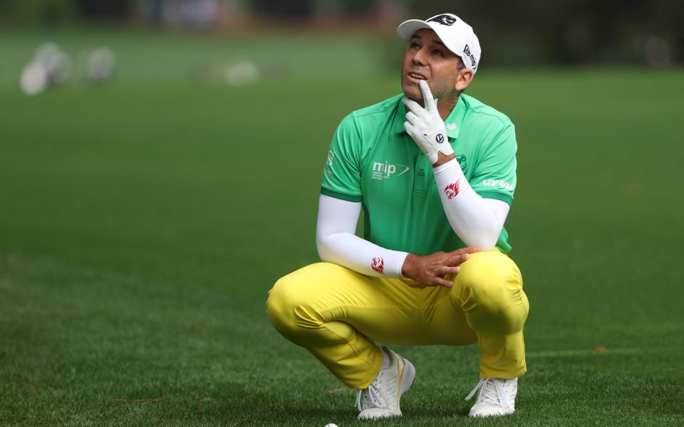 Spain's Sergio Garcia looks up at trees alongside the 1st fairway during the first round