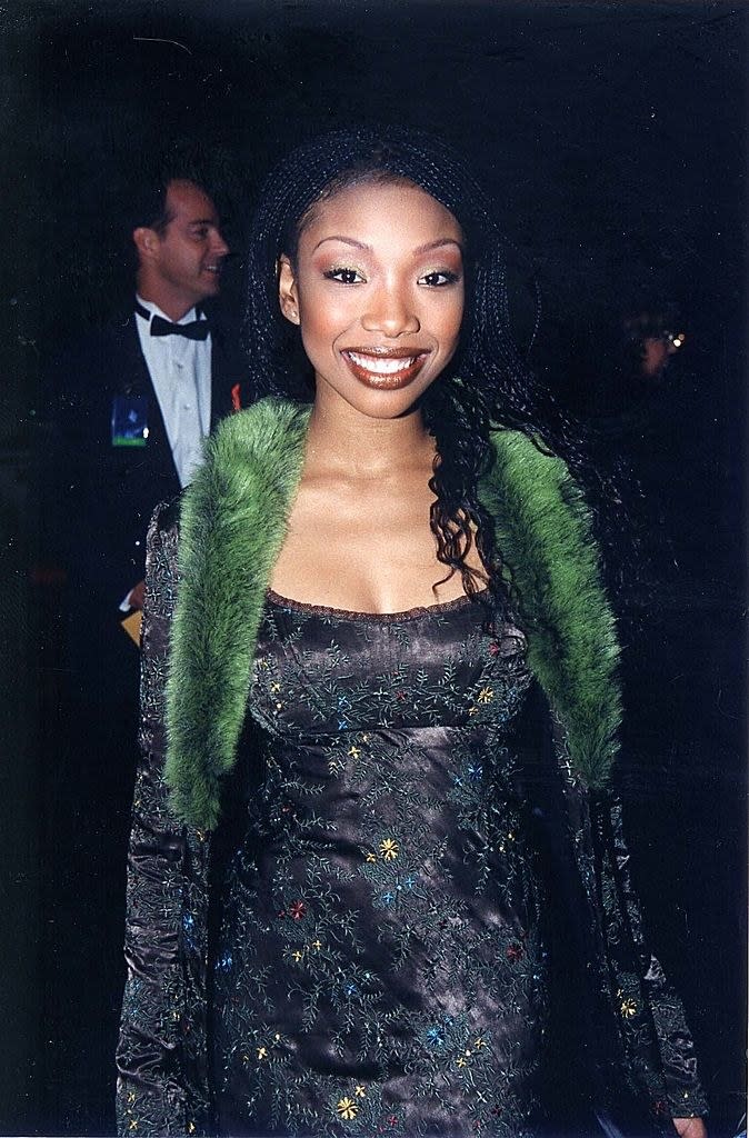 Brandy at the cable ace awards in a slip dress and a coat with fur trim on the collar