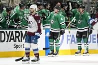 Dallas Stars' Miro Heiskanen (4) and Jason Robertson (21) celebrate with the bench, behind Colorado Avalanche's Andrew Cogliano (11), after Heiskanen scored during the second period in Game 2 of an NHL hockey Stanley Cup second-round playoff series in Dallas, Thursday, May 9, 2024. (AP Photo/Tony Gutierrez)