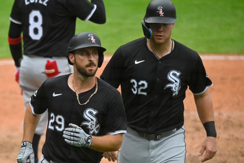 The Chicago White Sox's Paul DeJong (29) celebrates his two-run home run beside Gavin Sheets (32) against the Cleveland Guardians on Thursday in Cleveland.