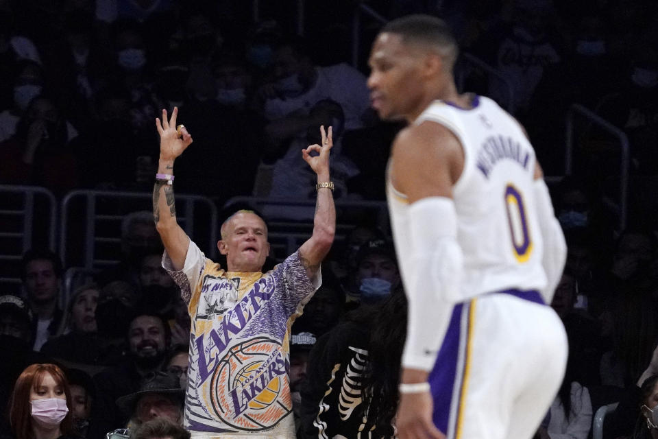 Red Hot Chili Peppers bass player Michael Balzary, known professionally as Flea, cheers after the Los Angeles Lakers scored as guard Russell Westbrook stands on the court during the first half of an NBA basketball game against the Houston Rockets Sunday, Oct. 31, 2021, in Los Angeles. (AP Photo/Mark J. Terrill)