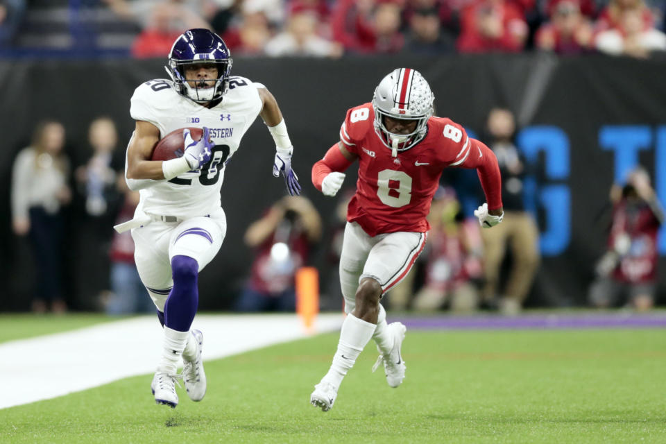 Northwestern running back John Moten IV, left, runs for a touchdown past Ohio State cornerback Kendall Sheffield during the first half of the Big Ten championship NCAA college football game, Saturday, Dec. 1, 2018, in Indianapolis. (AP Photo/AJ Mast)