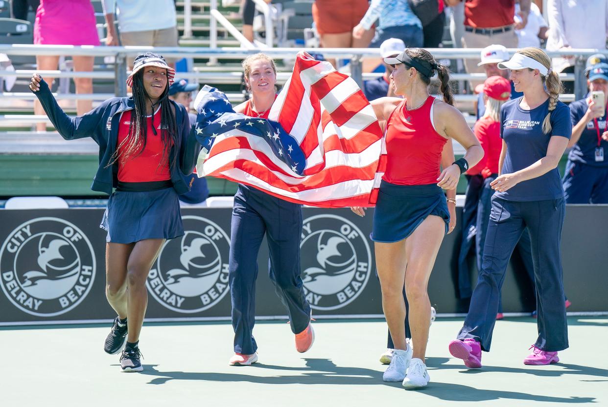 Members of the U.S. team, Jessica Pegula, Coco Gauff, Caty McNally, Sofia Kenin and Danielle Collins, celebrate Saturday after winning the Billie Jean King Cup qualifier against Austria at the Delray Beach Tennis Center.