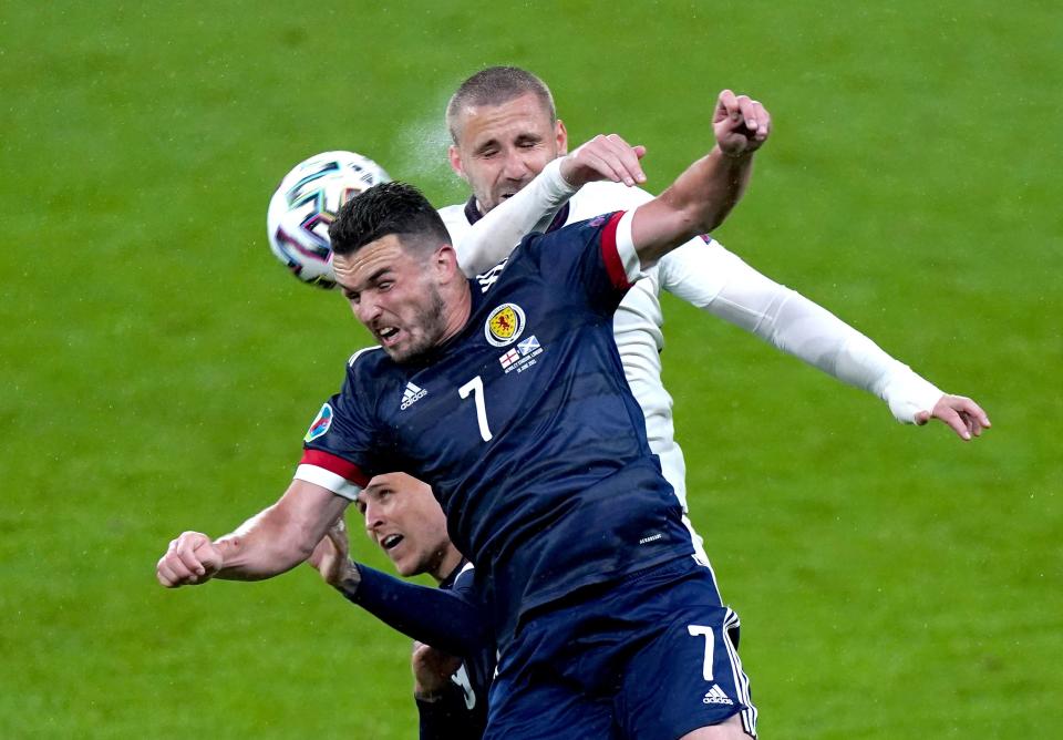 John McGinn and Luke Shaw battle for the ball (PA)