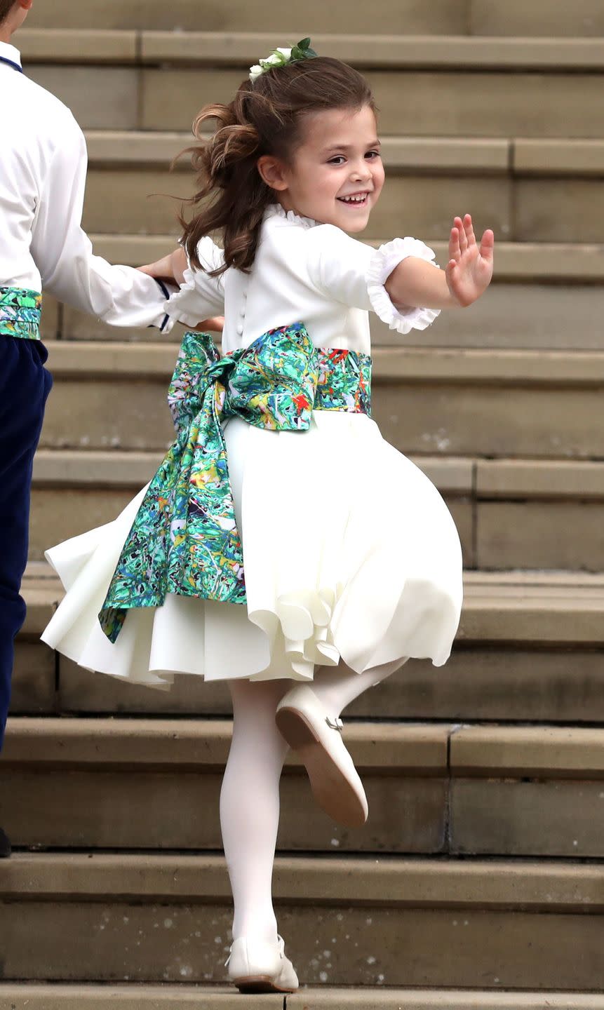 Bridesmaid Theodora Williams skips up the steps