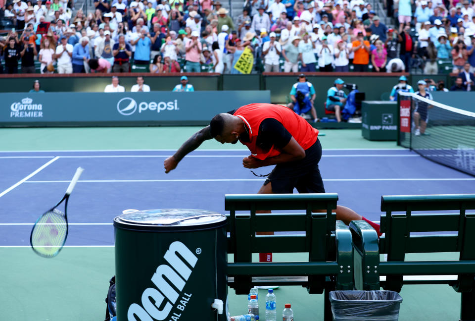 INDIAN WELLS, CALIFORNIA - MARCH 17  Nick Kyrgios of Australia smashes his racket after his three set defeat against Rafael Nadal of Spain in their quarterfinal match on Day 11 of the BNP Paribas Open at the Indian Wells Tennis Garden on March 17, 2022 in Indian Wells, California. (Photo by Clive Brunskill/Getty Images)