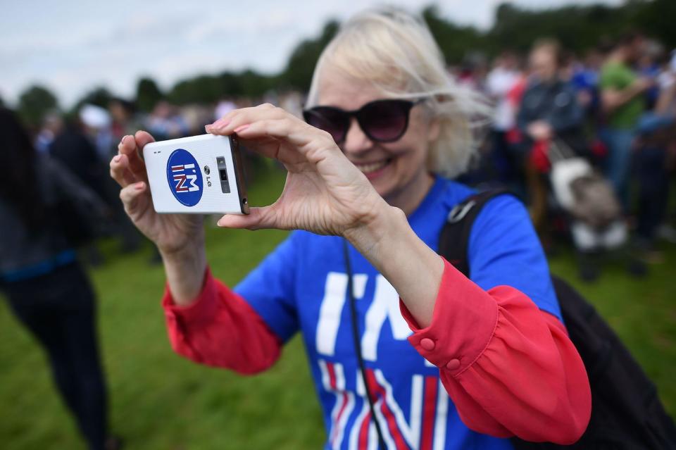 A woman uses a smartphone to take a photograph as she attends a rally for 'Britain Stronger in Europe', the official 'Remain' campaign group seeking to a avoid Brexit: BEN STANSALL/AFP/Getty Images