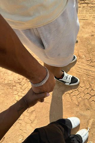 <p>Simone Biles/Instagram</p> Simone Biles and Jonathan Owens holding hands at the construction site of their new home in September.