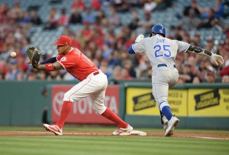 June 5, 2018; Anaheim, CA, USA; Kansas City Royals center fielder Jon Jay (25) is out at first against Los Angeles Angels third baseman Jefry Marte (19) in the third inning at Angel Stadium of Anaheim. Mandatory Credit: Gary A. Vasquez-USA TODAY Sports