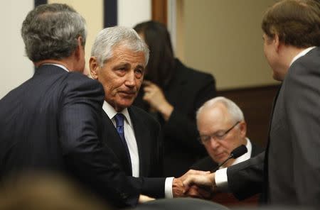 U.S. Defense Secretary Chuck Hagel greets members of Congress as he arrives to testify about the Bergdahl prisoner exchange at a House Armed Services Committee hearing on Capitol Hill in Washington June 11, 2014. REUTERS/Jonathan Ernst