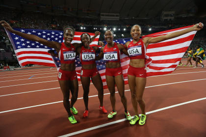 Carmelita Jeter, Bianca Knight, Allyson Felix, and Tianna Madison celebrate after winning the Women's 4 x 100m Relay Final (Getty Images)