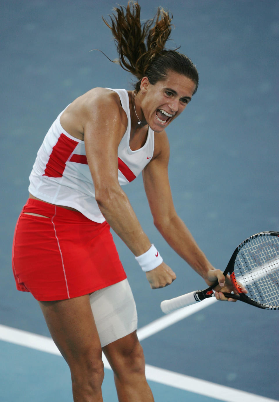 ATHENS - AUGUST 19: Amelie Mauresmo of France celebrates her win over Svetlana Kuzentsova of Russia in the women's singles tennis quarterfinal match on August 19, 2004 during the Athens 2004 Summer Olympic Games at the Olympic Sports Complex Tennis Centre in Athens, Greece. (Photo by Clive Brunskill/Getty Images)