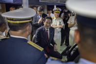 Japan's Prime Minister Fumio Kishida, center, sits on the bridge of the BRP Teresa Magbanua ship at the Philippine Coast Guard headquarters on Saturday Nov. 4, 2023 in Manila, Philippines. (Ezra Acayan/Pool Photo via AP)