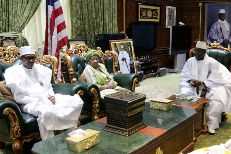 Nigerian President Muhammadu Buhari (L) and Liberian President Ellen Johnson Sirleaf (C) meet Gambian President Yahya Jammeh (R) in Banjul on January 13, 2017