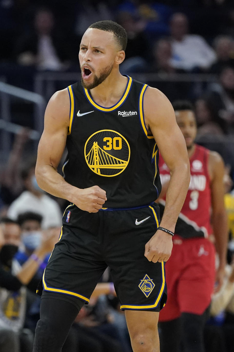 Golden State Warriors guard Stephen Curry (30) celebrates after shooting a three-point basket against the Portland Trail Blazers during the first half of an NBA basketball game in San Francisco, Friday, Nov. 26, 2021. (AP Photo/Jeff Chiu)