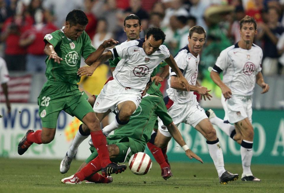 Landon Donovan taking on the Mexican defense. <a href="https://www.gettyimages.com/detail/news-photo/landon-donovan-of-the-usa-tries-to-run-through-the-defense-news-photo/54463453?phrase=U.S.%20mexico%20soccer%20Columbus&adppopup=true" rel="nofollow noopener" target="_blank" data-ylk="slk:Jonathan Daniel/Getty Images;elm:context_link;itc:0;sec:content-canvas" class="link ">Jonathan Daniel/Getty Images</a>