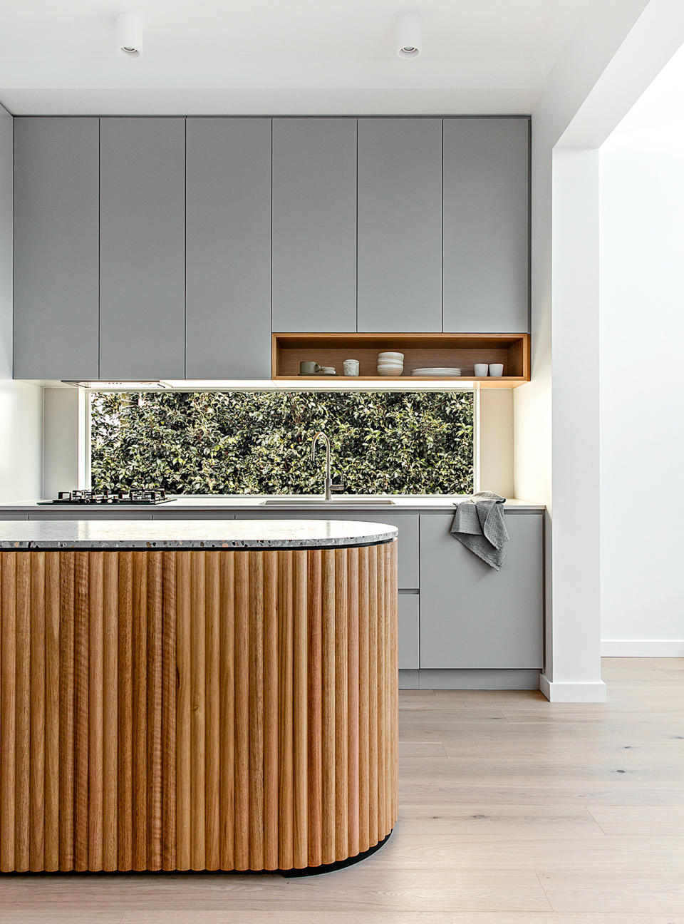 Kitchen with fluted island and handleless cabinetry