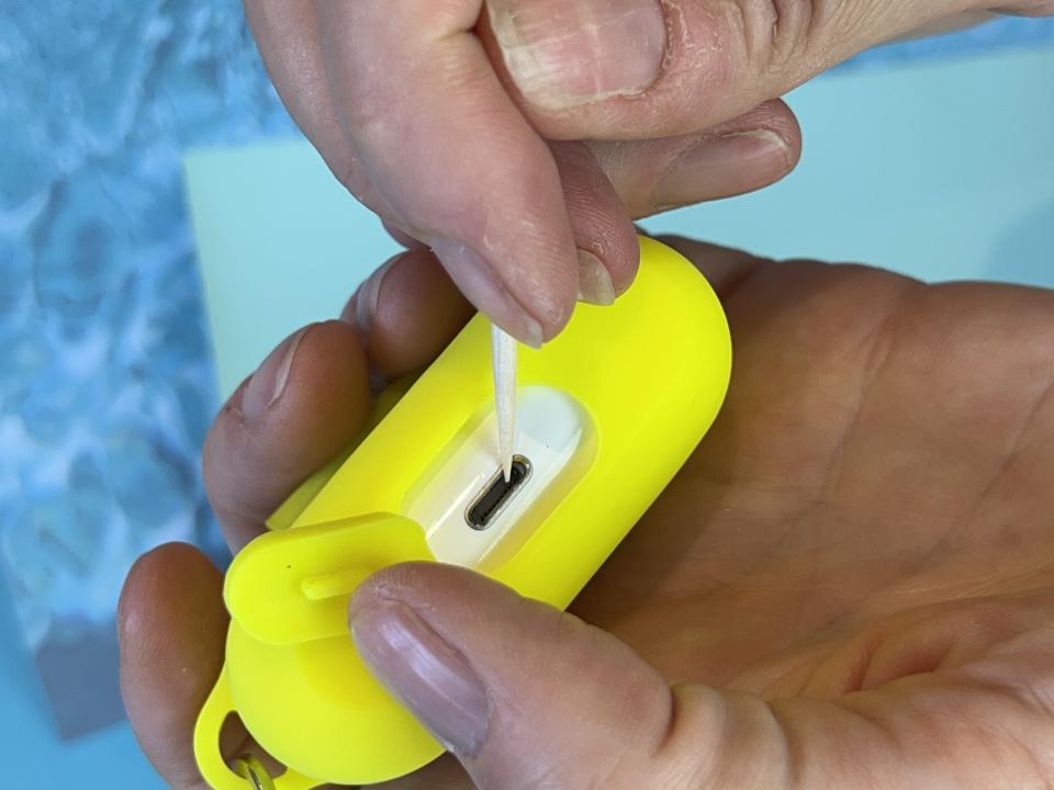 Close up view of woman cleaning AirPods