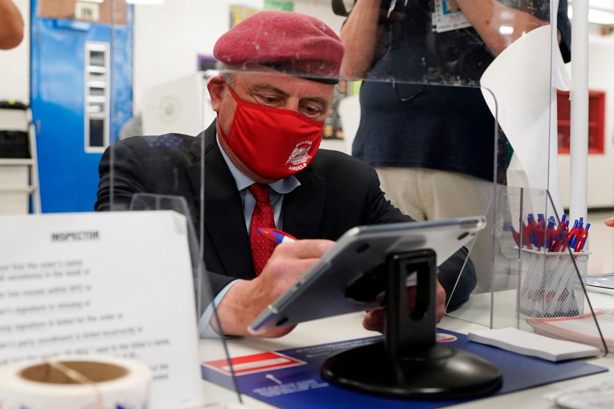 Republican candidate for New York mayor Curtis Sliwa signs in to vote at Frank McCourt High School, in New York on Tuesday, June 22, 2021. The final votes are set to be cast Tuesday in New York's party primaries, where mayors, prosecutors, judges and city and county legislators will be on the ballot, along with other municipal offices.