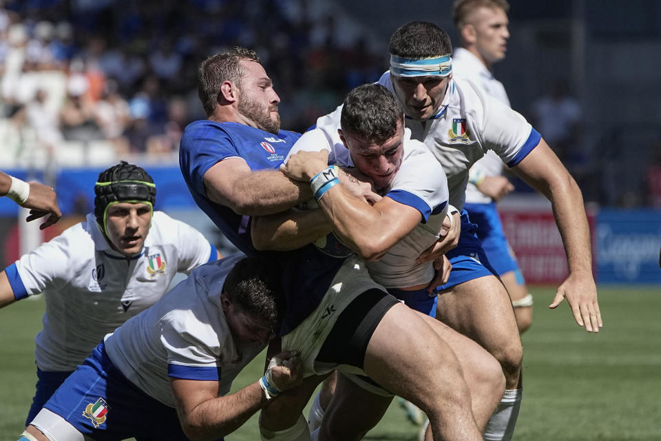 Namibia's Wian Conradie, left, and Italy's Paolo Garbisi challenge for the ball during the Rugby World Cup Pool A match between Italy and Namibia at the Geoffroy Guichard stadium in Saint-Etienne, central France, Saturday, Sept. 9, 2023. (AP Photo/Laurent Cipriani)