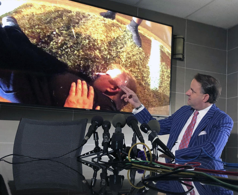 Attorney Geoff Henley points out details in body camera footage from 32-year-old Tony Timpa's 2016 death in the custody of Dallas police officers during a press conference, Friday, Aug. 2, 2019 in Dallas. Two Dallas police officers involved in the arrest of a 911 caller who died in their custody told commanders they mocked the handcuffed man as part of a "strategy" to get him to respond. (AP Photo/Jake Bleiberg)