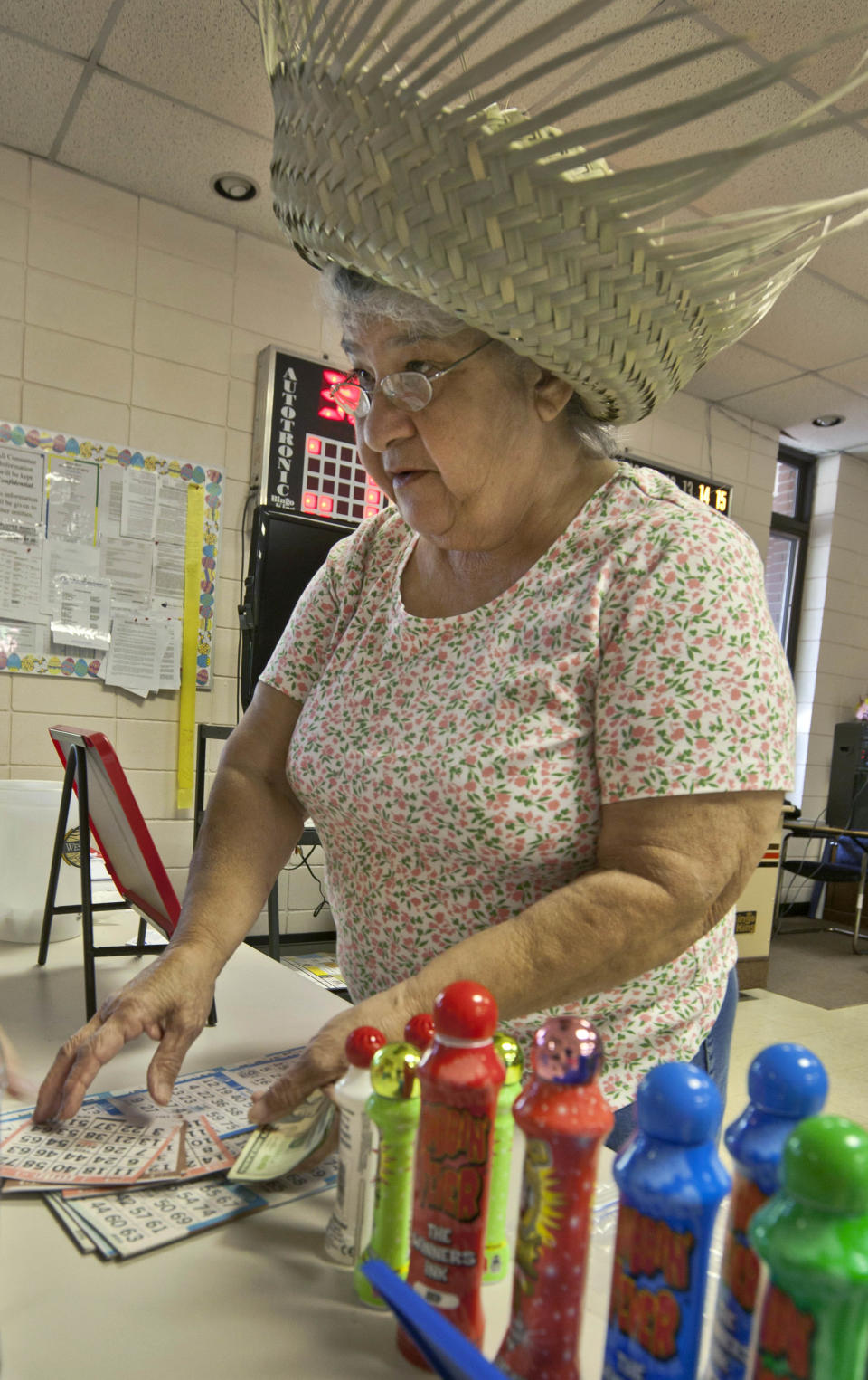 In this photo taken Tuesday, April 10, 2012, Joyce Landers of Searcy, Ark., purchases Bingo cards before playing in Bald Knob, Ark. (AP Photo/Danny Johnston)