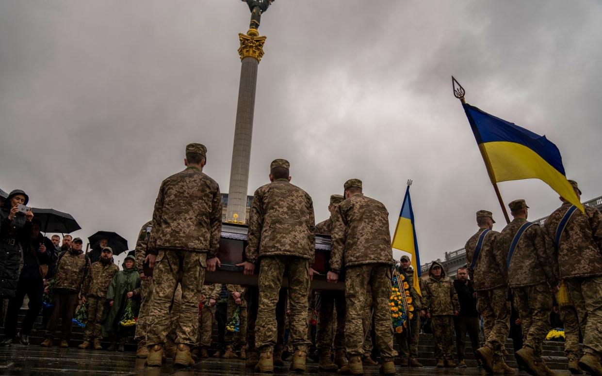 Honour guards carry the coffin of Ukrainian army paramedic Nazarii Lavrovskyi