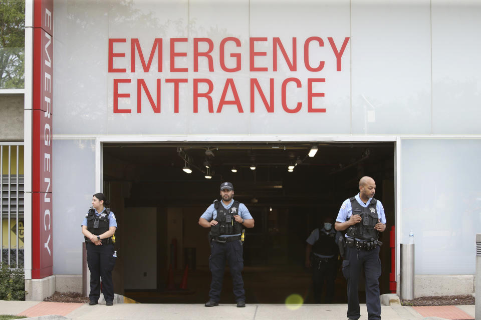 Police officers stand outside Advocate Christ Medical Center after multiple law enforcement officers were shot in the Morgan Park area of Chicago on Wednesday, July 7, 2021. Police say three undercover law enforcement officers were shot and wounded while driving onto an expressway on Chicago’s South Side. (Antonio Perez/Chicago Tribune via AP)